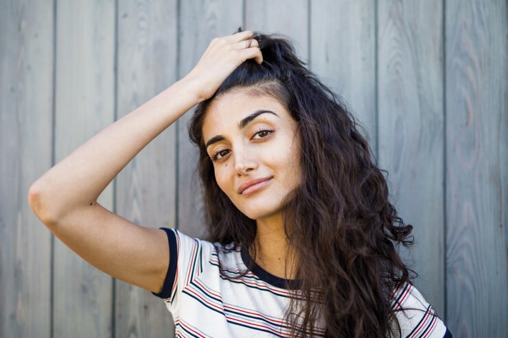 portrait-young-woman-standing-against-wooden-wall_1048944-8117254